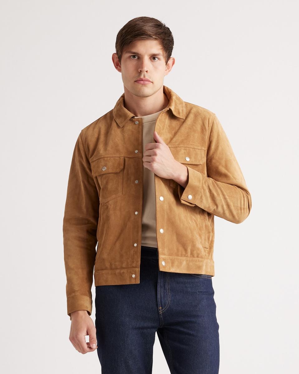 Man wearing a Quince Italian Suede Trucker Jacket in the Cognac coloway. 