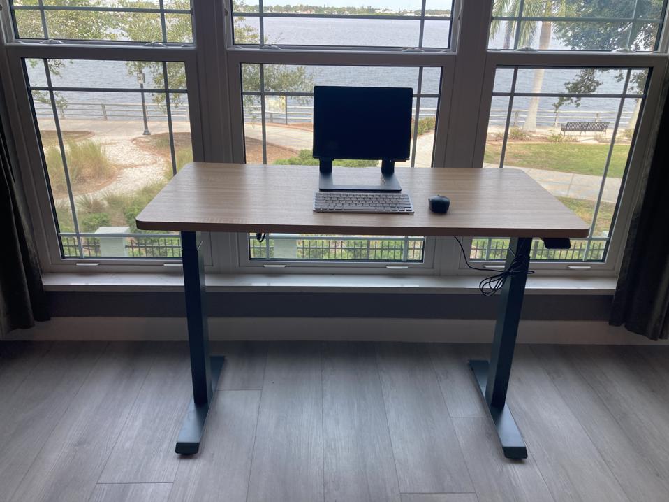 Branch Duo desk with laptop, against a window