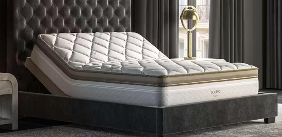 The Saatva Solaire Mattress with the head of the bed tilted up on an adjustable bed frame