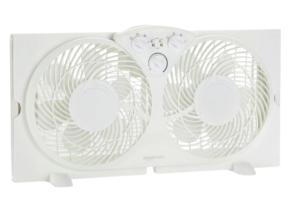 Amazon Basics Window Fan with removable feet on a white background.