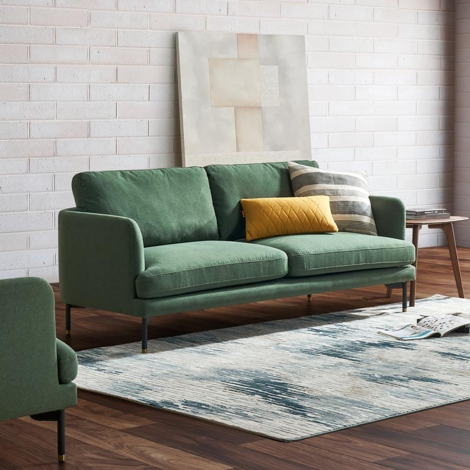 The Castlery Pebble Loveseat in a living room with a blue and white rug