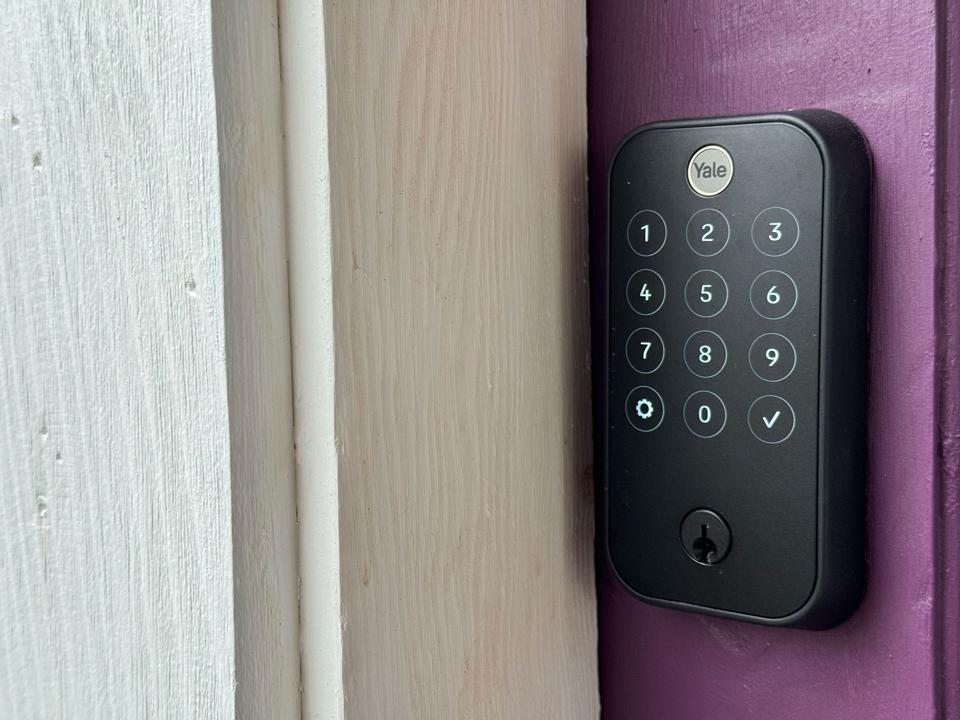 A photo of a Yale Assure Lock 2 Touch on a purple door.