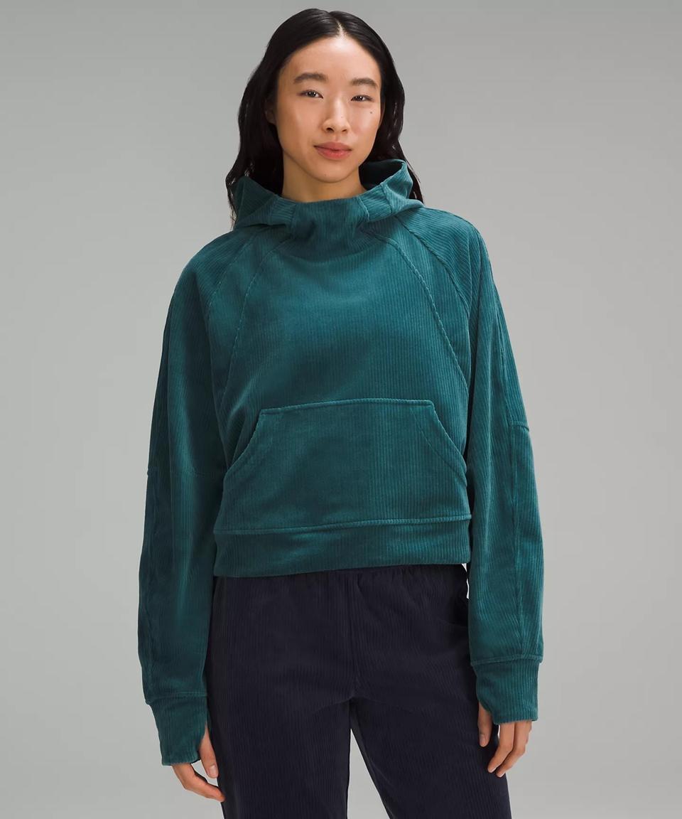 A woman wearing the Scuba Oversized Hoodie in the color teal.