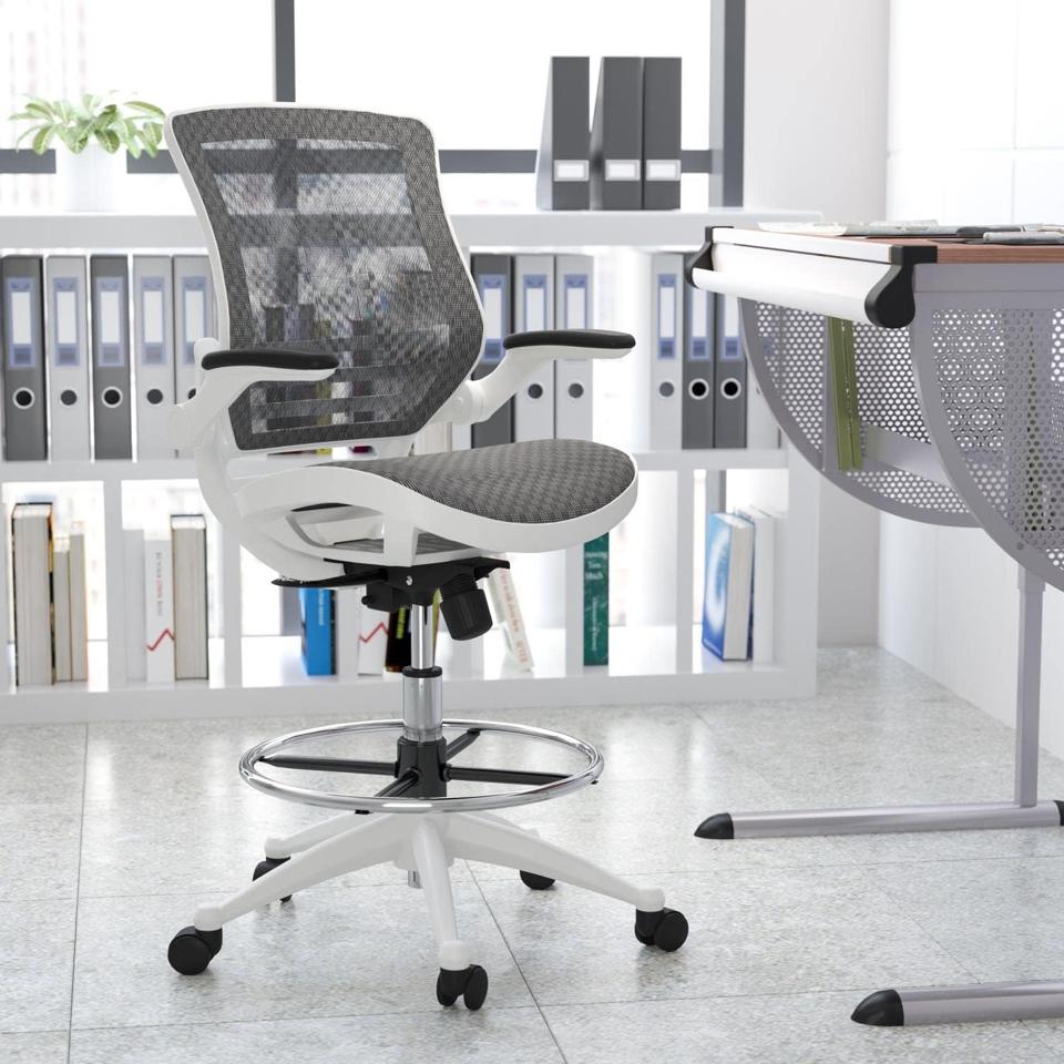 A white and gray Flash Furniture Waylon Office Chair in an office with a standing desk