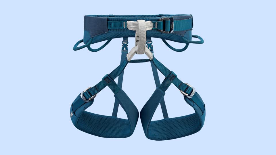 A picture of the Petzl Adjama harness on a light blue background