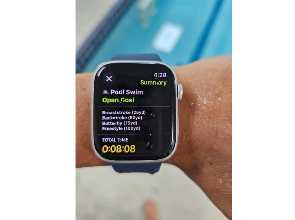 Apple Watch Series 9 on left wrist of forbes vetted staffer w/ pool in the background