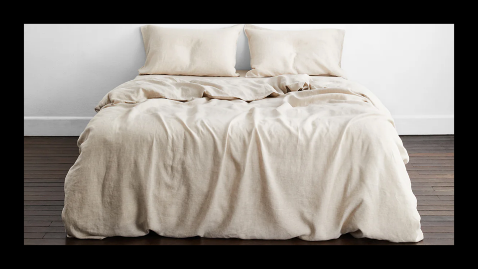 A bed made with a pair of linen sheets from Bed Threads