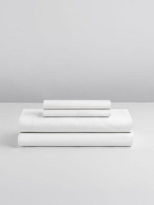 Stack of Four Seasons Sheets on a white background