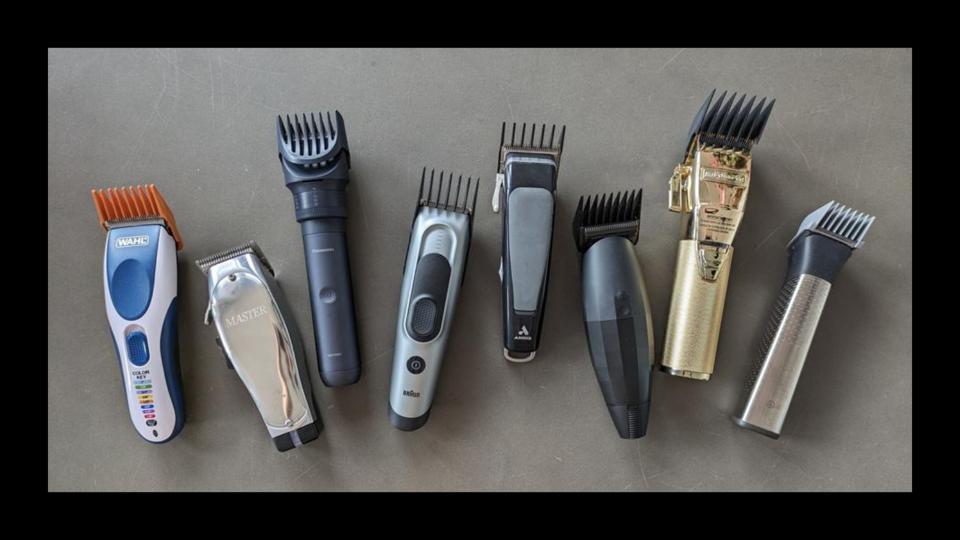 Eight electric hair clippers side by side on a gray countertop