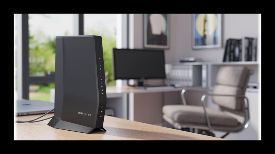 A modem-router combo on a desk in an office.