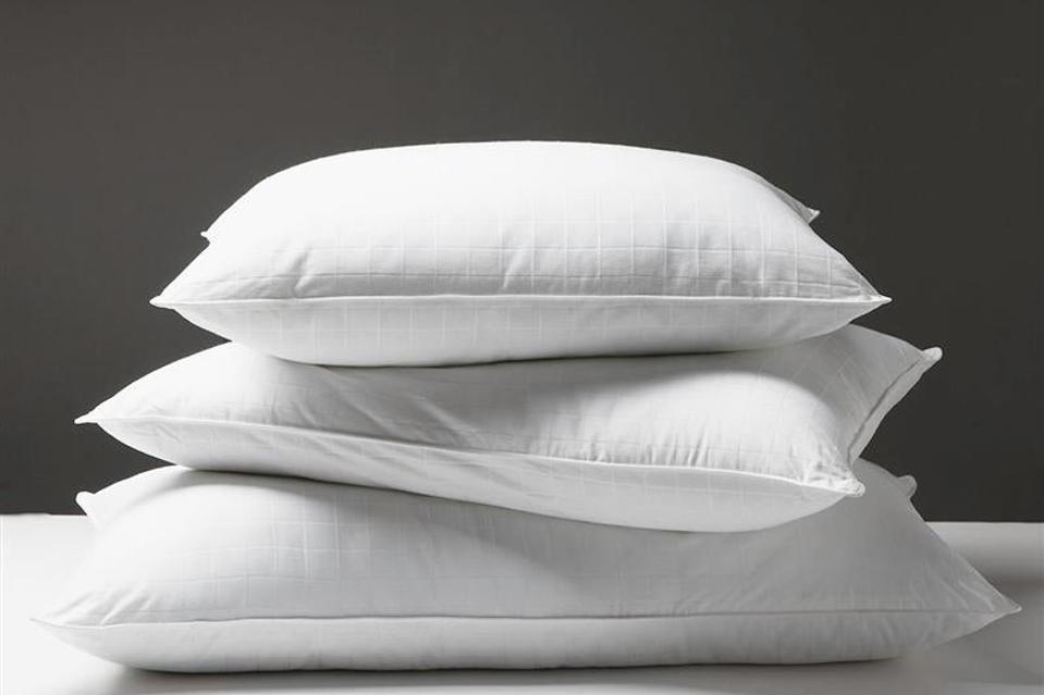 Stack of Sobella Pillows on a white surface with a gray background