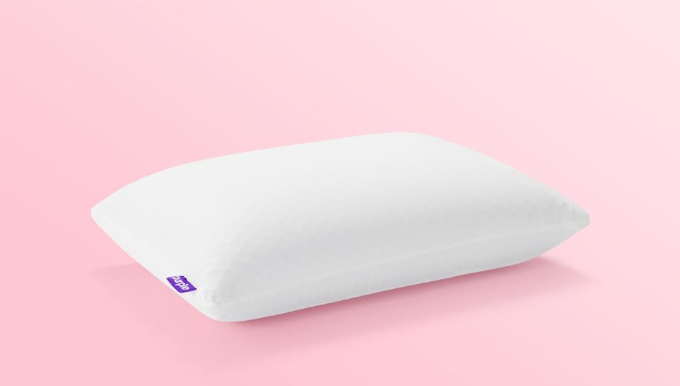 The Purple Harmony Pillow on a pink background. 