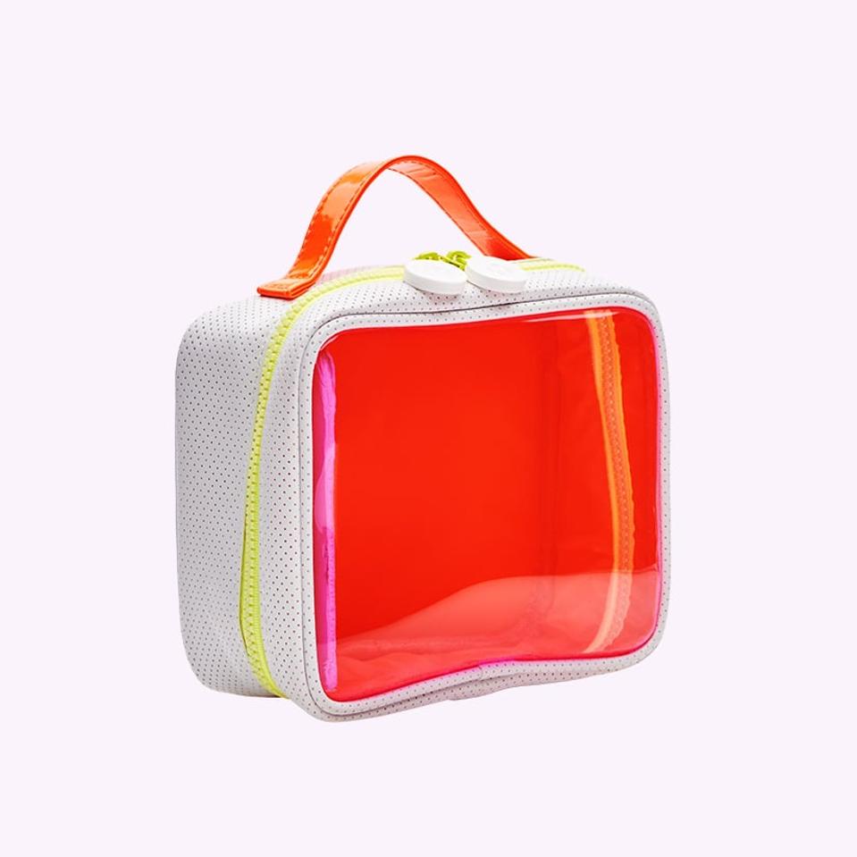 Orange travel makeup bag with white sides.