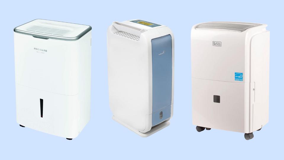 Three dehumidifiers against a baby blue background. 