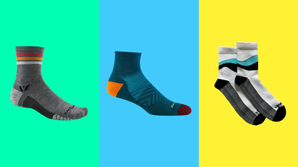 Three different pairs of running socks on a tri-colored background