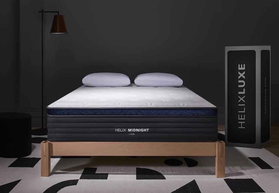 Product shot of the Helix Midnight Luxe mattress in a black room. 