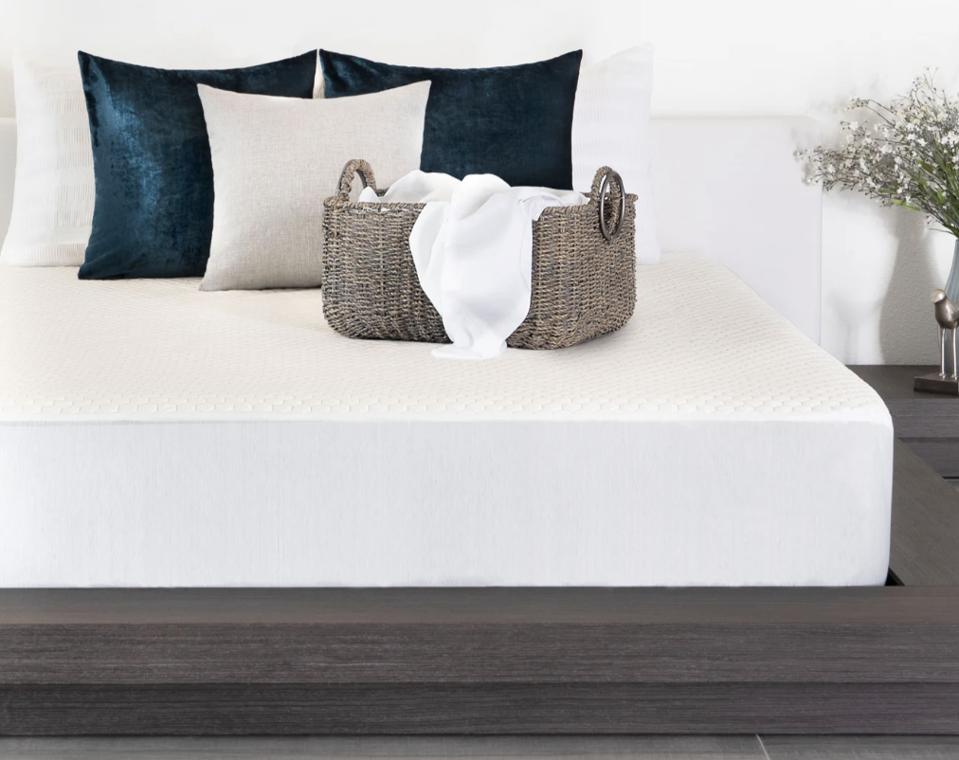 Brooklyn Bedding Luxury Cooling Mattress Protector over a mattress on a wood bed frame