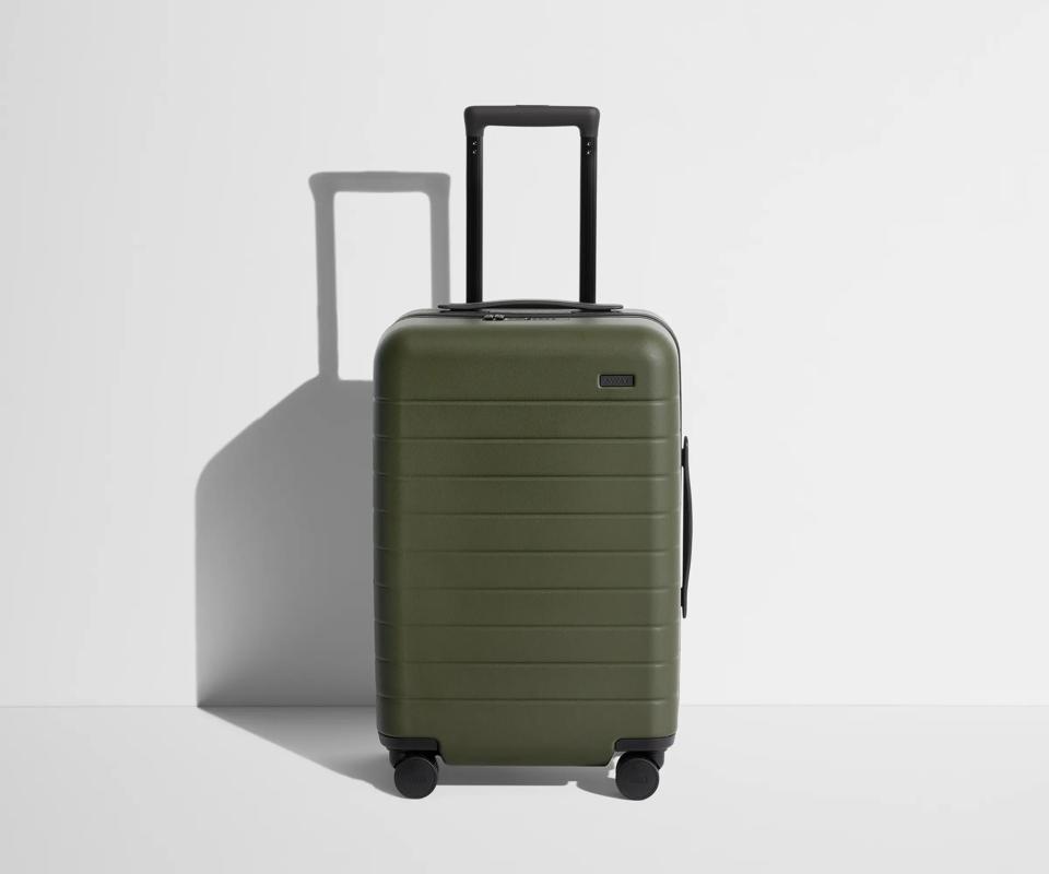 Green suitcase against a white background.