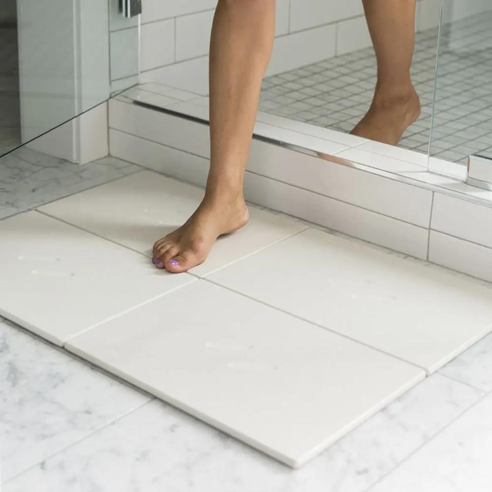 Dorai Home Large Bath Stone Mat outside of a shower.