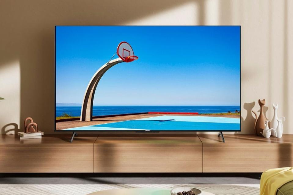 The Hisense U6N TV in a living room on a TV stand