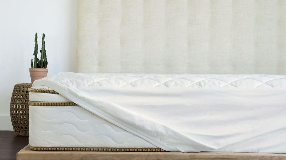 Saatva Organic Mattress Pad on top of a mattress. 