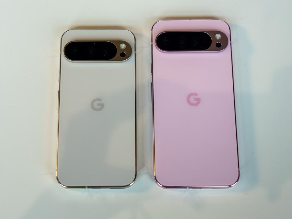 Two Google Pixel phones in porcelain and pink on a white tabletop.