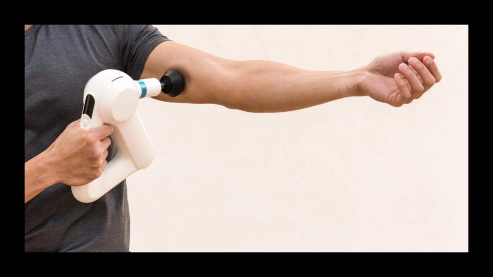 A person using the Theragun Elite on their arm.