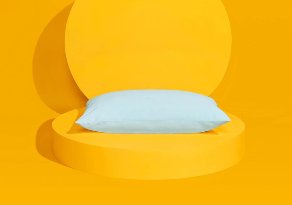 The Slumber Cloud Ultra Cool Pillow on a yellow background. 