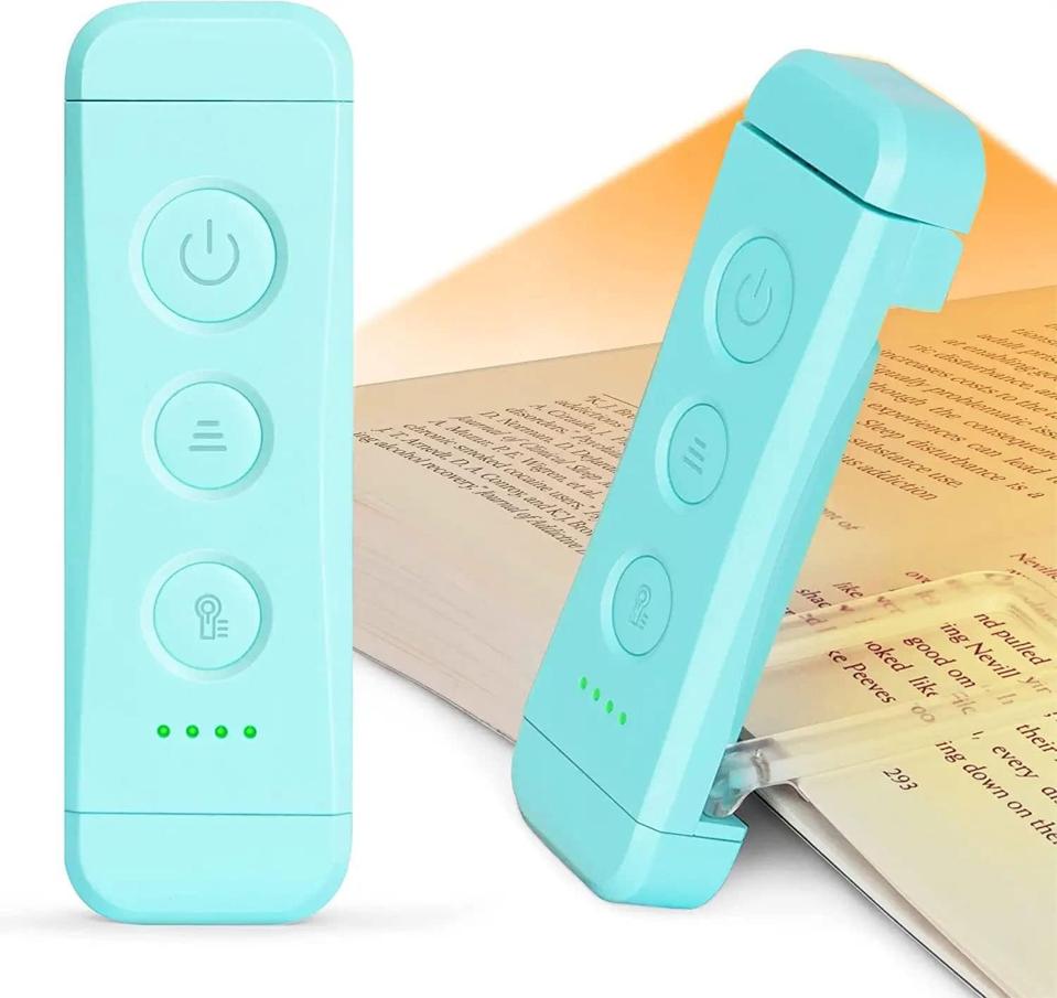 A blue Glocusent USB Rechargeable Book Light attached to a book.