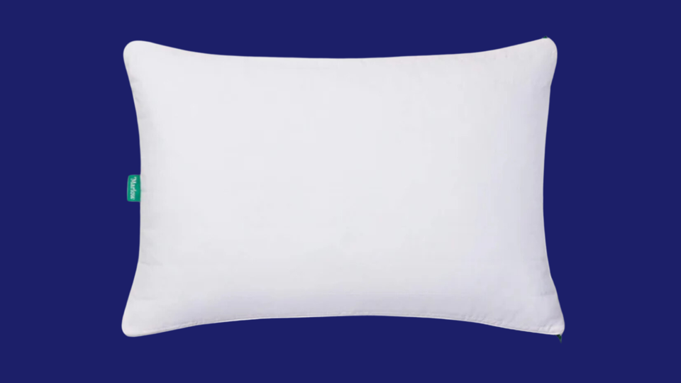 The Brooklinen Marlow Pillow against a blue background. 