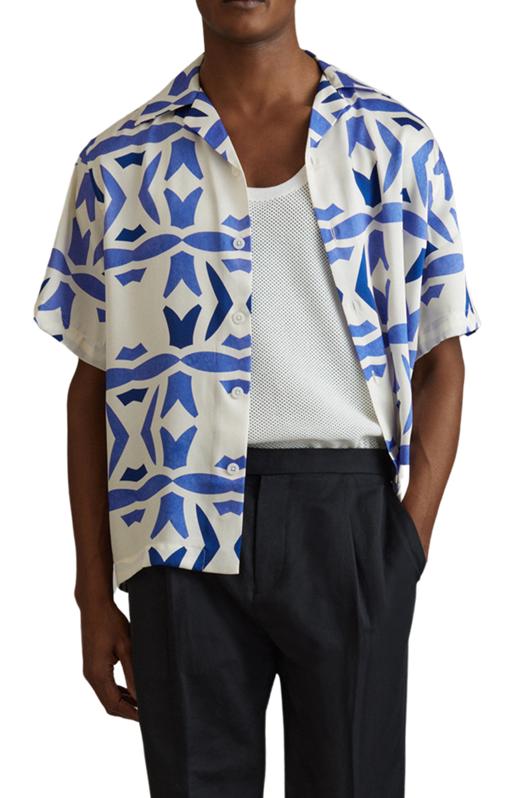 Man wearing a Reiss Purkiss Geo Print Camp Shirtin the White/ Bright Blue pattern. 