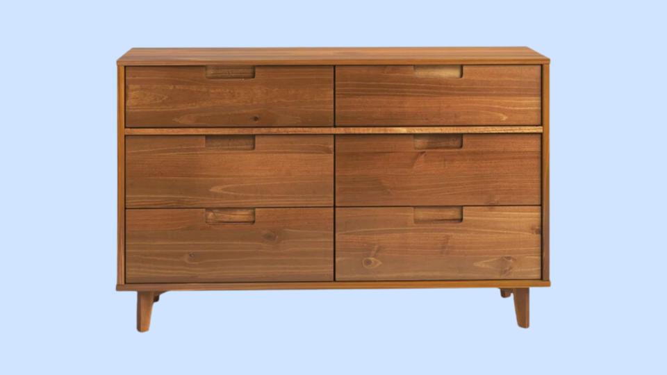 Mercury Row Yarber Six-Drawer Dresser against light blue background.