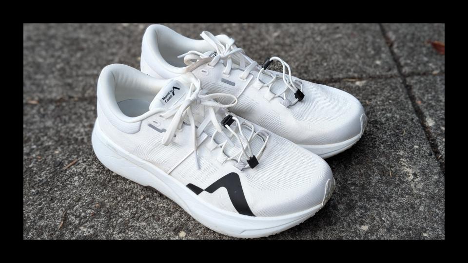 The Mount to Coast R1 ultra running shoes in white on a concrete background