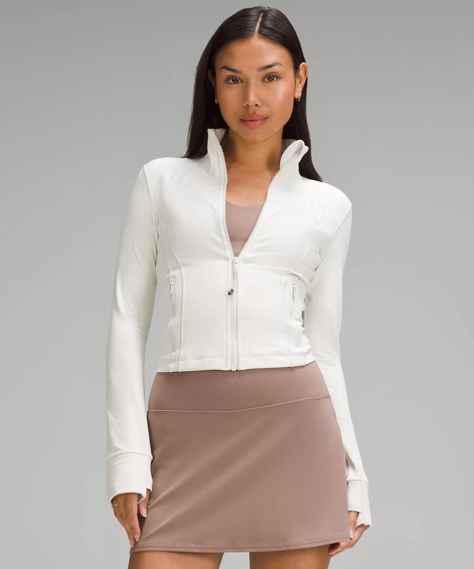 Woman wearing a white Lululemon Define Cropped Jacket Nulu