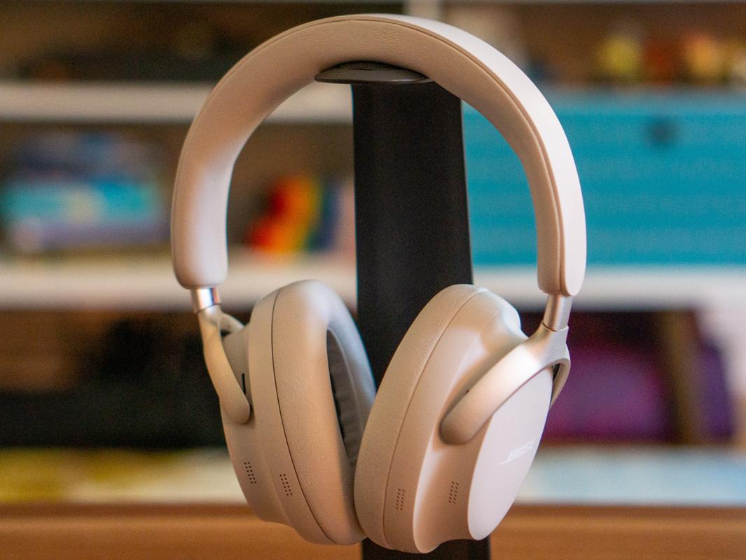 Bose QuietComfort Ultra headphones hanging on a headphone stand