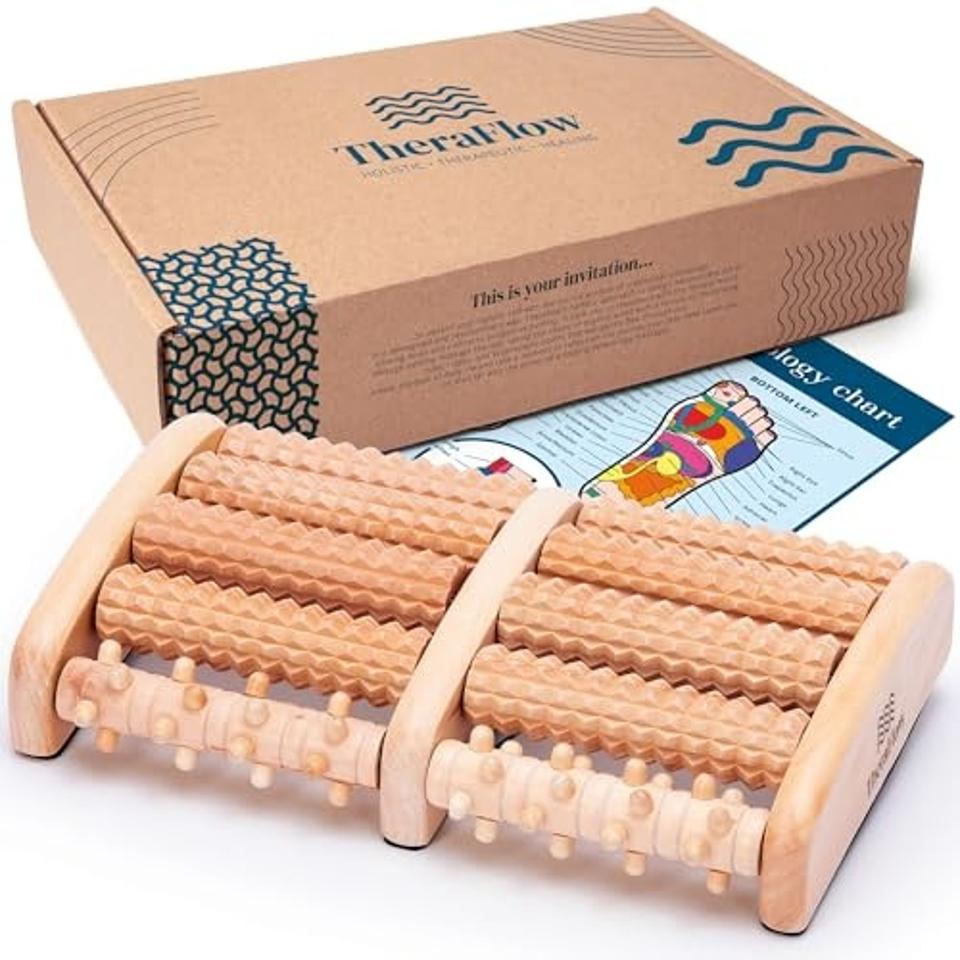 a wooden foot massager with box and instructions on a white background