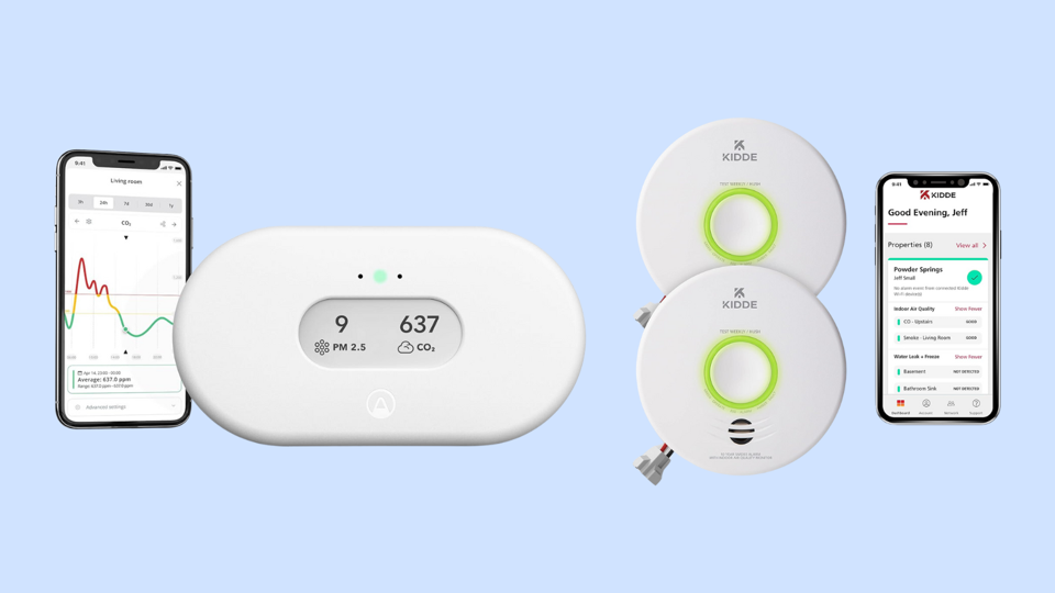 Two indoor air quality monitors on a light blue background.