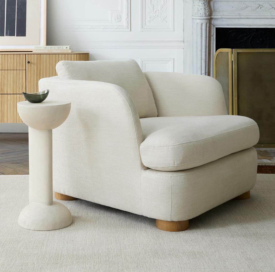 A white Leroy Chair in a modern living room, styled next to a pedestal table