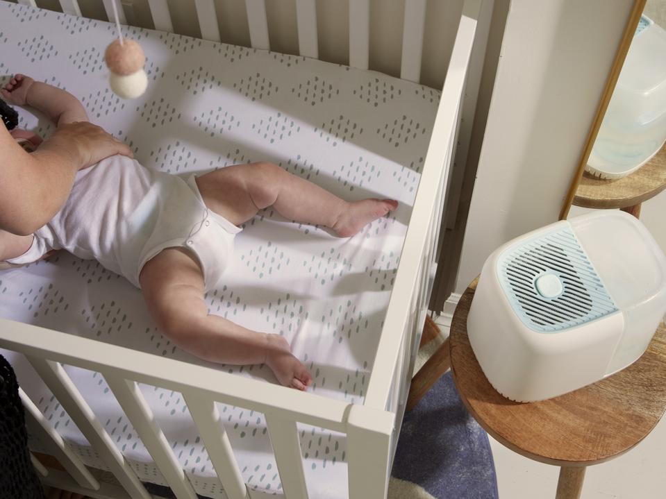 Canopy Humidifier on a stool near a baby in the crib