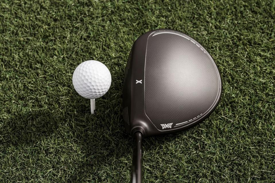 PXG 0311 Black Ops Driver in black next to a golf ball in grass