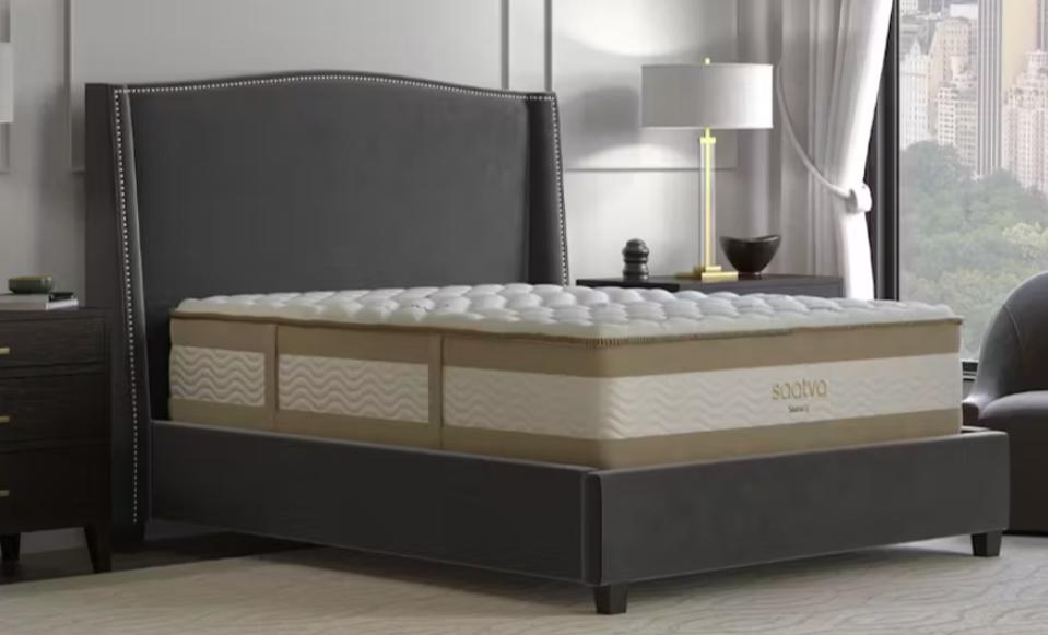 The Saatva Rx Mattress on a bed frame in a well-lit bedroom