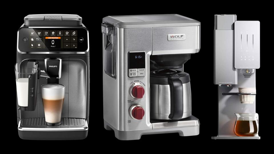 Three high-end coffee makers against a black background.