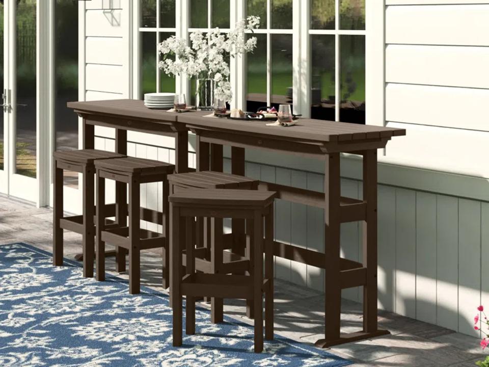 Lark Manor Arbnora Rectangular Four-Person Dining Set on patio.