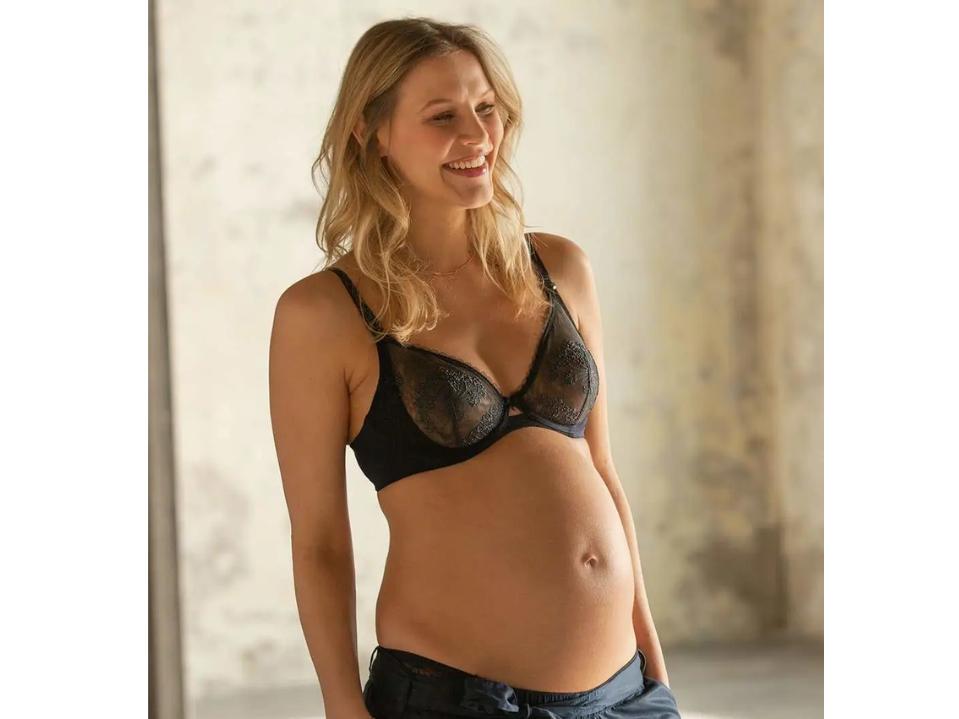 woman standing cache coeur maternity nursing black lace bra & black sweats indoors