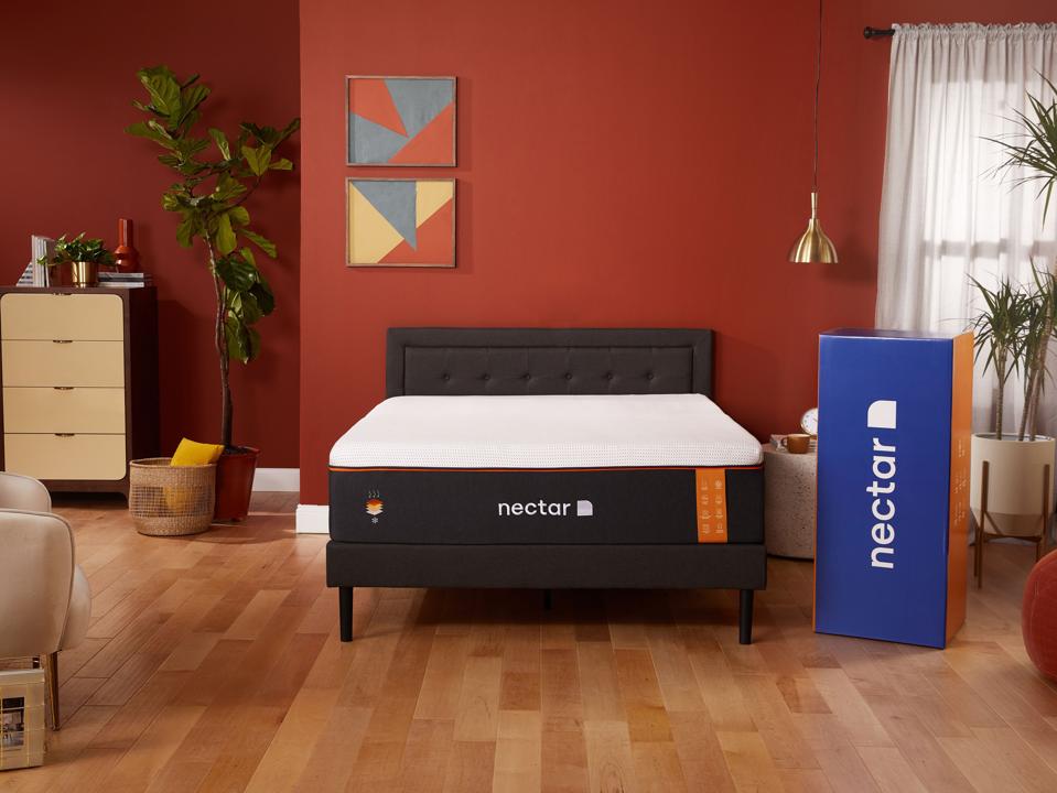 Nectar Premier Copper mattress on black bed frame in bedroom next to nectar box in daytime