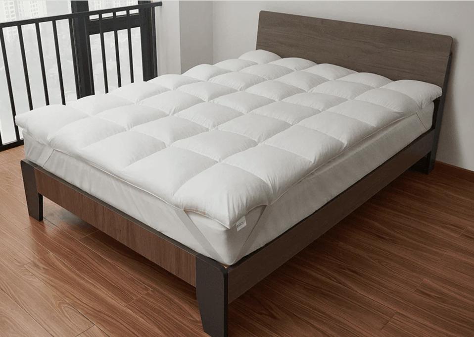 The Coop Retreat Mattress Topper on a bed 