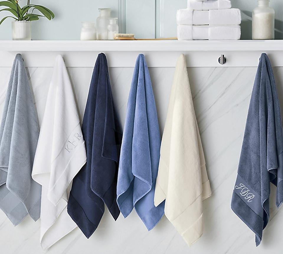 Lifestyle shot of white and blue Frontgate Resort Collection Towels hanging in a bathroom 