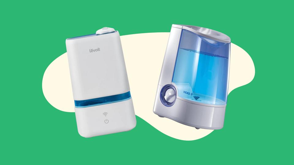 Two humidifiers against a green background. 