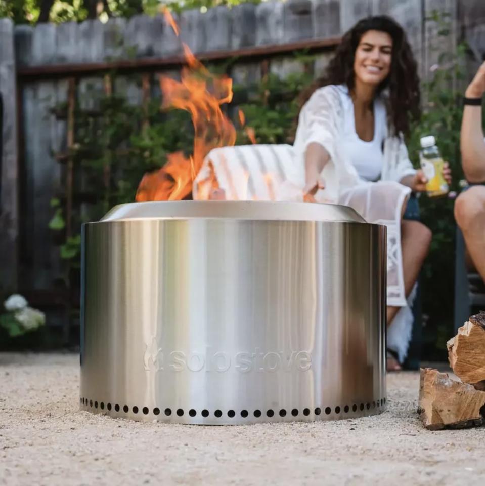 Solo Stove Yukon fire pirt with lady in background