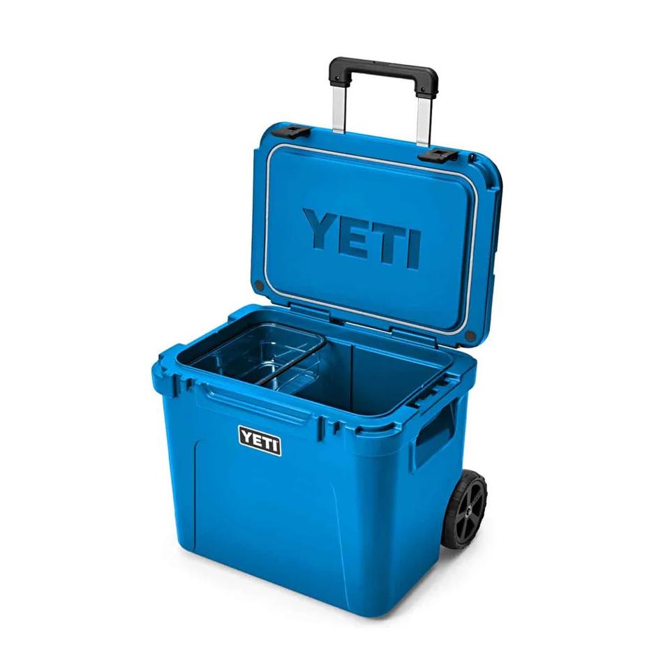 Yeti Roadie 60 Wheeled Cooler in blue on a white background